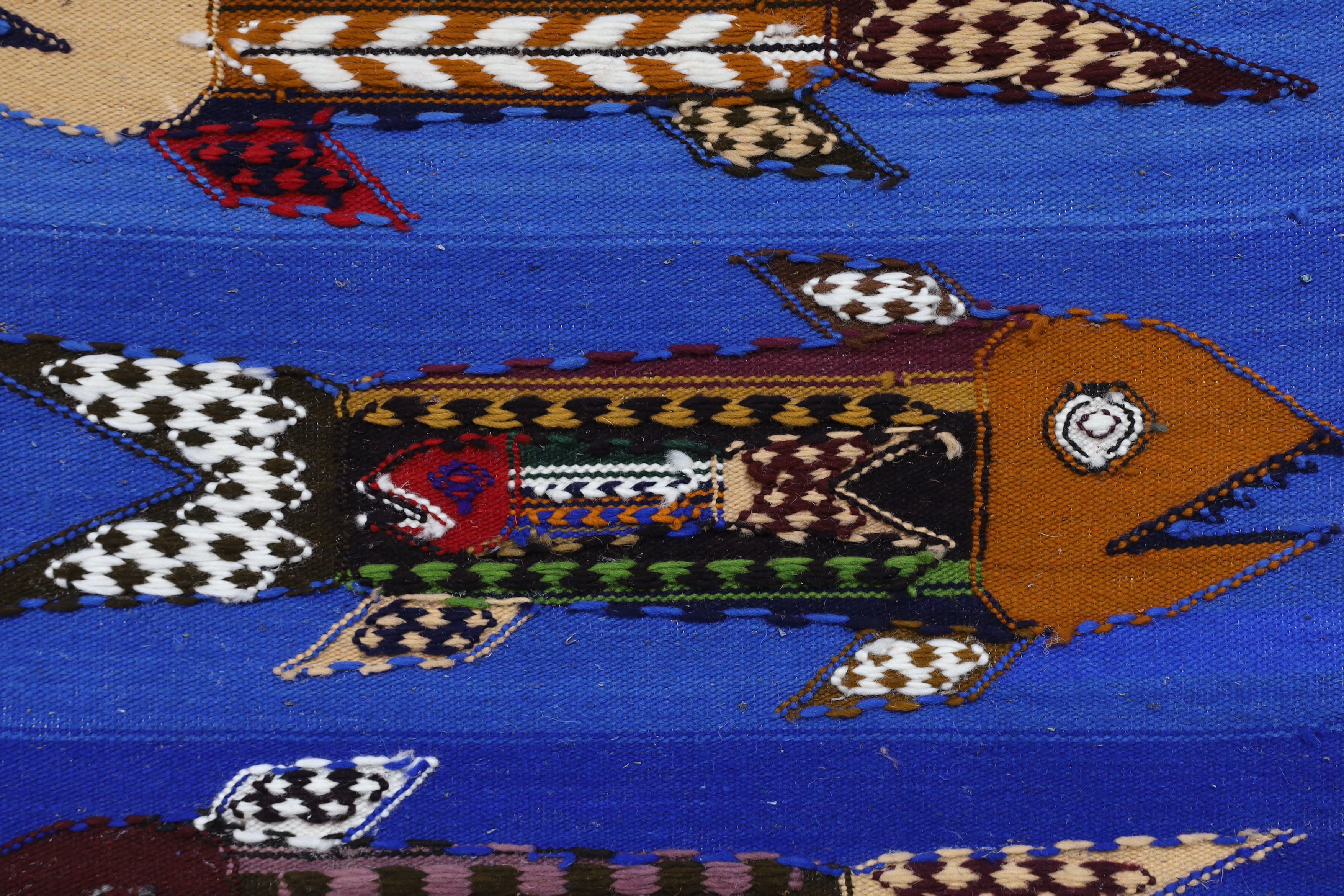 In the style of Evelyn Ackerman, hand hooked tapestry wall hanging, pregnant fish